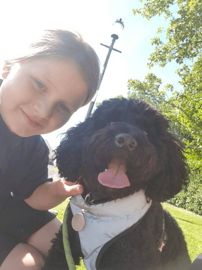 A pupil with a Baxter Project companion dog